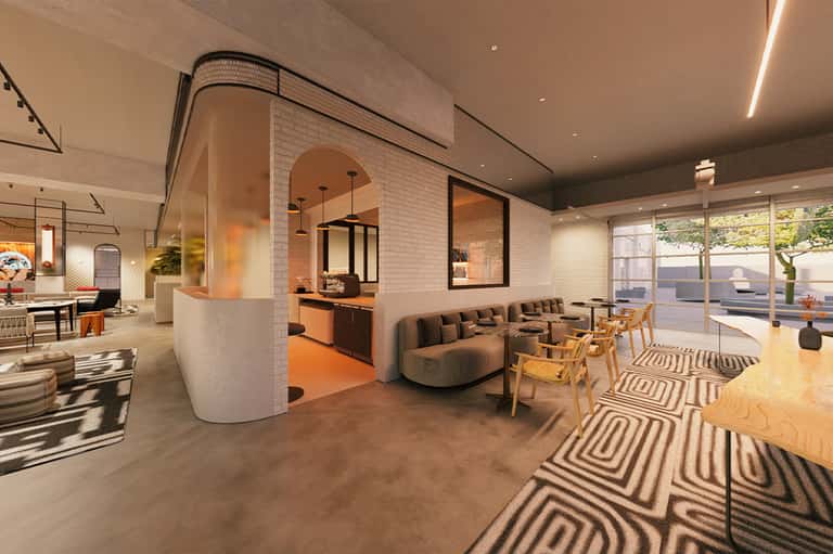 Modern hotel lobby with curved white brick walls, orange accents, and casual seating