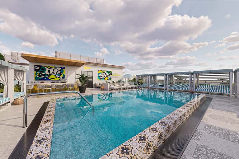 Rooftop pool with turquoise water, lounge seating, and modern pavilion under blue sky