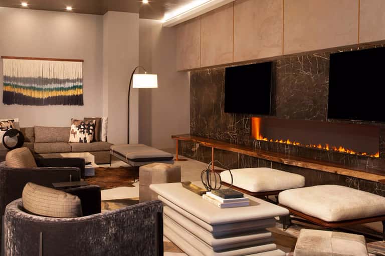 Contemporary living room with fireplace, neutral furnishings, and entertainment center with TV