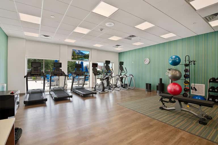 Modern fitness center with treadmills, exercise bikes, and wellness equipment