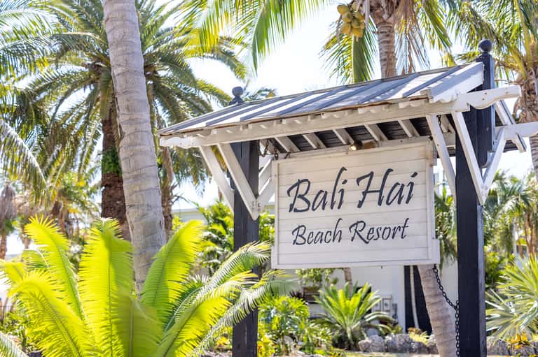 Bali Hai Beach Resort sign among palm trees and tropical vegetation