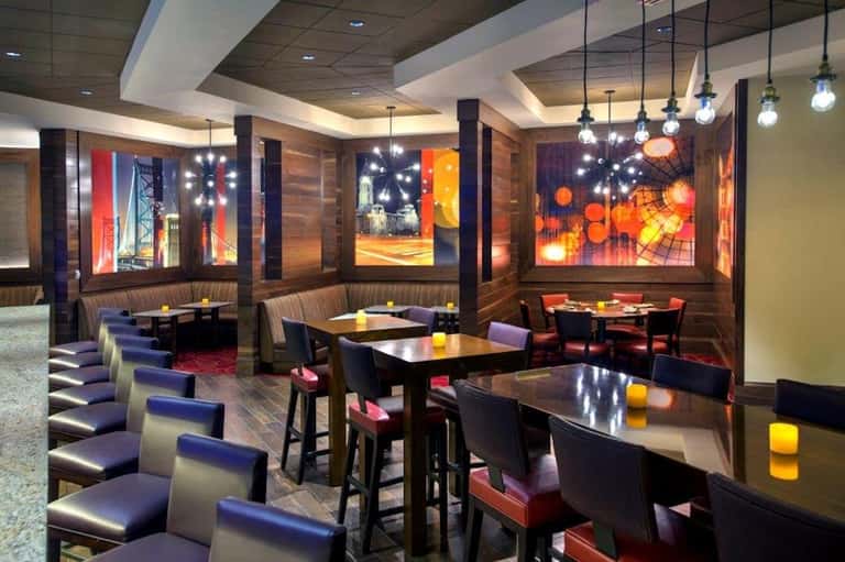 Modern lounge with colorful digital art displays and contemporary seating areas