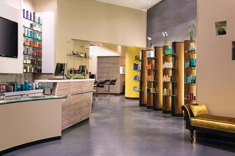Modern spa reception area with wood accents, shelving, and contemporary furnishings