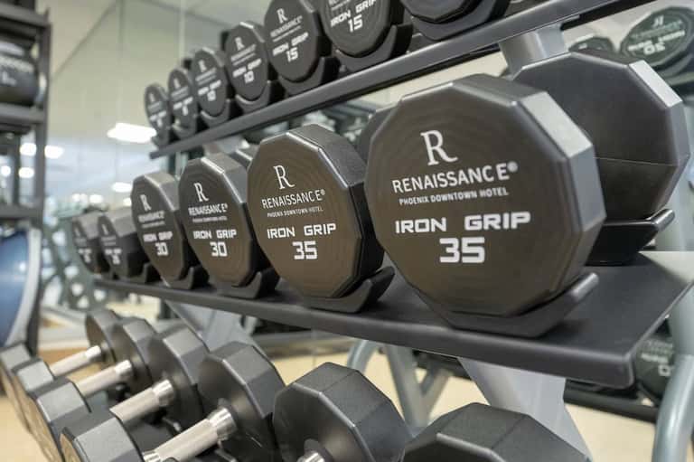Close-up of dumbbells with Renaissance hotel branding in gym fitness facility