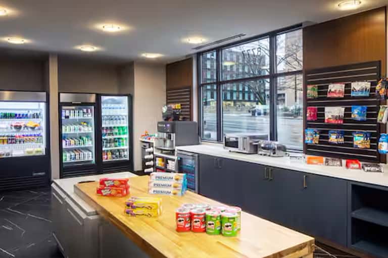Hotel convenience store with refrigerated beverages, snacks, and window storefront display