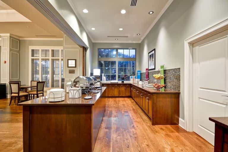 Luxury kitchen with wooden cabinetry, granite countertops, and glass-paned doors