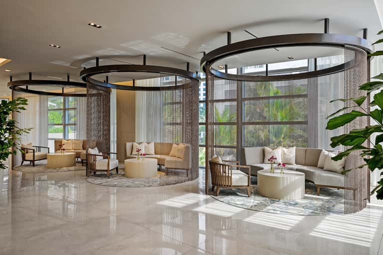 Contemporary spa lounge with circular mesh-enclosed seating areas and cream-colored furnishings