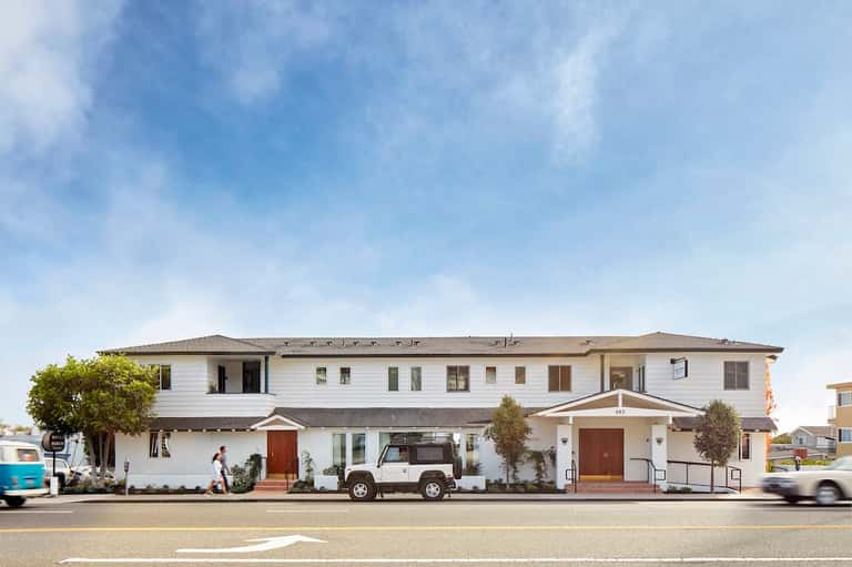 Contemporary white hotel building exterior with modern architecture and landscaping
