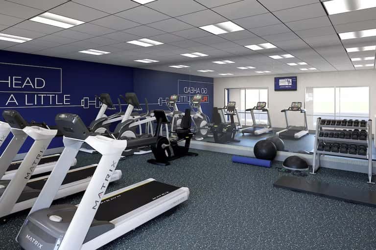 Modern fitness center with treadmills, exercise bikes, and strength training equipment