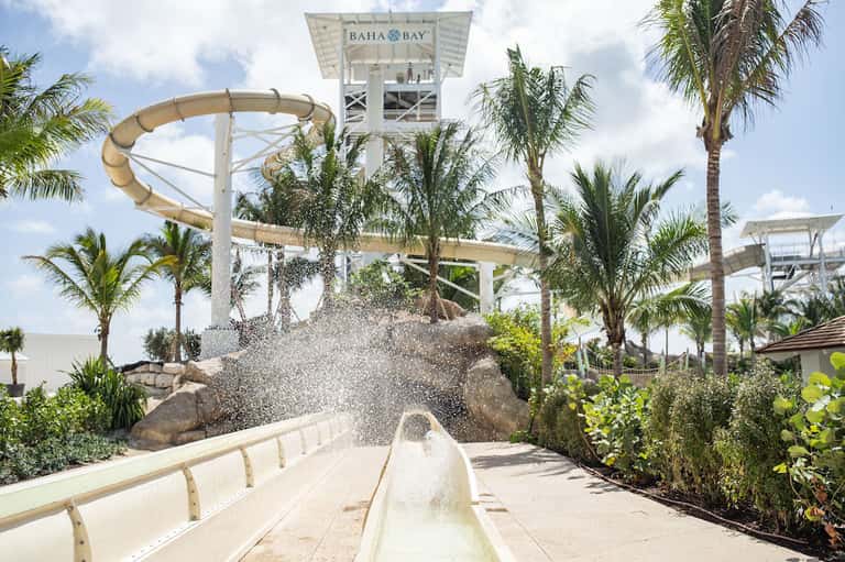 Water slide at Baha Bay water park with palm trees and splash effect