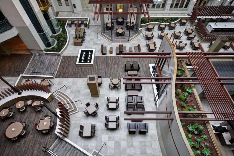 Aerial view of multi-level outdoor courtyard with seating areas, lounge chairs, and landscaping