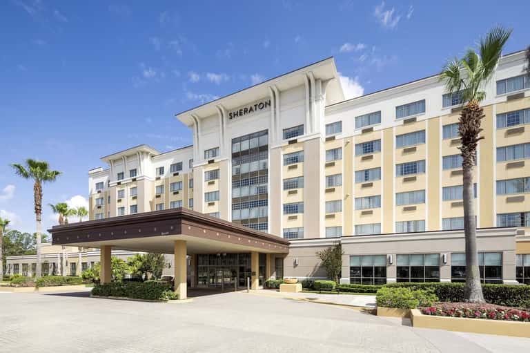 Sheraton hotel exterior with cream and yellow facade and landscaped grounds