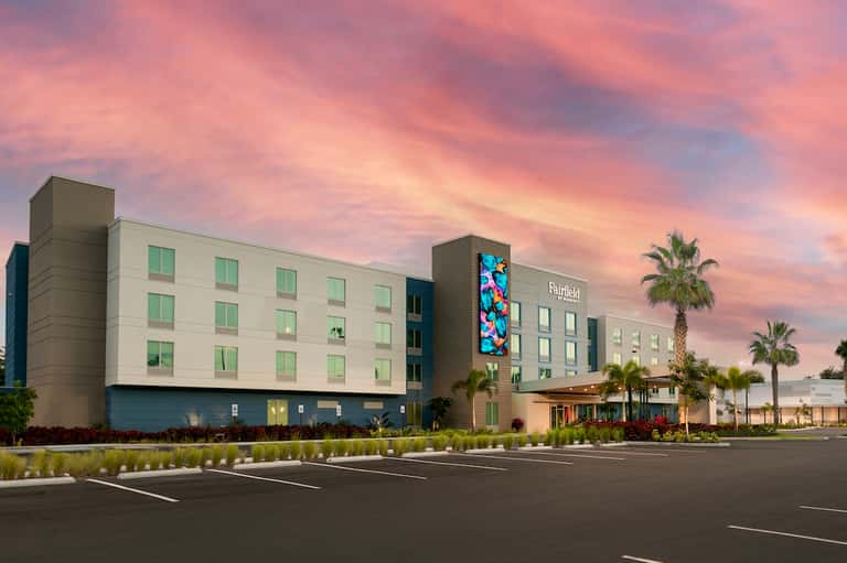 Fairfield hotel exterior at dusk with modern architecture and tropical landscaping