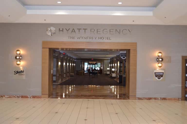 Hyatt Regency Wynfrey Hotel entrance with modern signage and polished marble flooring