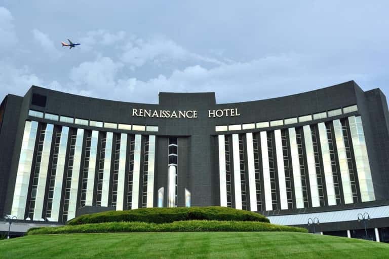 Renaissance Hotel exterior with distinctive curved dark facade and manicured green lawn