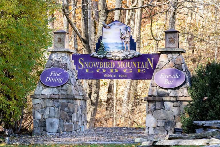 Stone entrance gate to Snowbird Mountain Lodge with fine dining and fireside bar signage