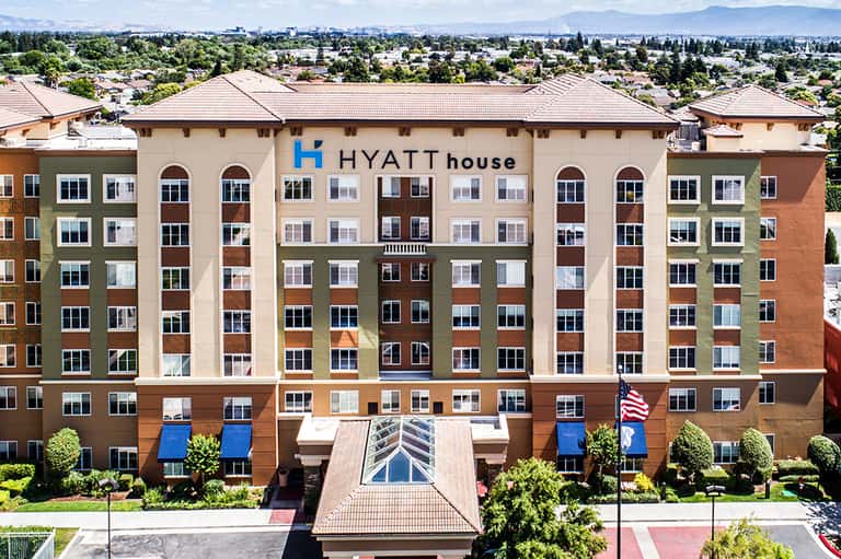 Hyatt House exterior showing multi-story building with colorful facade and mountain backdrop