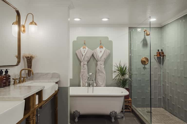 Luxury bathroom with freestanding soaking tub, dual sinks, walk-in shower, and spa amenities