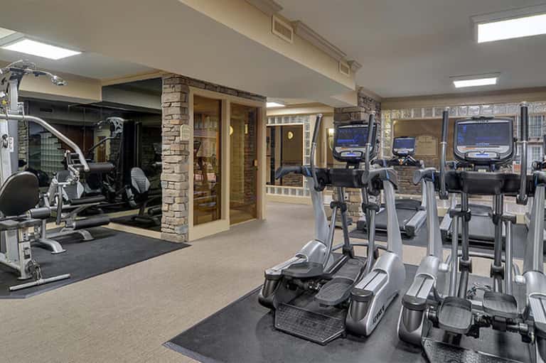 Modern fitness center with cardio equipment, exercise bikes, and treadmills in spacious room