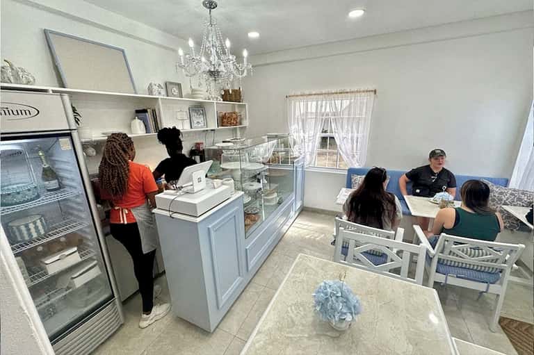 Boutique cafe interior with counter service, seating area, and crystal chandelier
