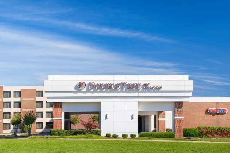 DoubleTree hotel exterior with modern brick and white facade under clear blue sky