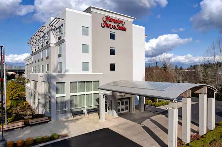 Hampton Inn and Suites modern white building with solar panel canopy entrance
