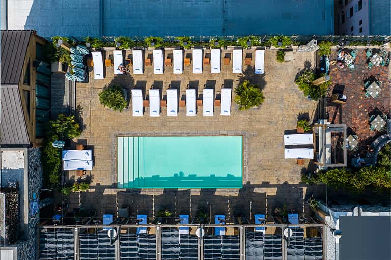 Aerial view of modern urban pool deck with loungers and geometric layout