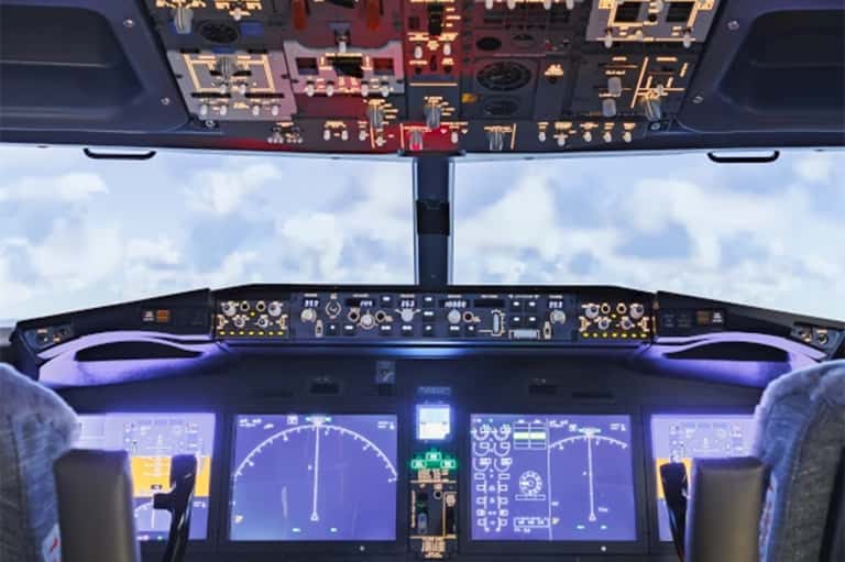 Aircraft cockpit view with instrument panels and sky visible through windscreen