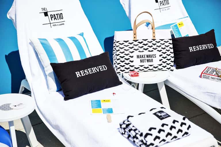 Reserved lounge chairs and branded merchandise at The Patio pool venue