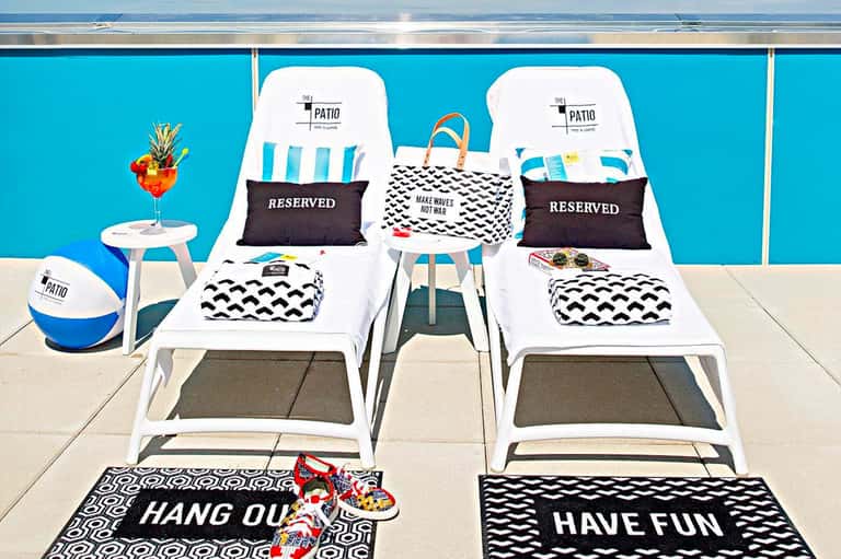 Poolside lounge chairs with reserved seating and fun beach-themed towels and decorations