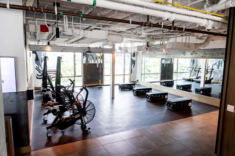 Fitness studio with stationary bikes and exercise equipment near large windows