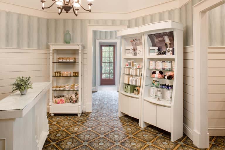 Luxury spa retail boutique with white shelving displaying skincare products