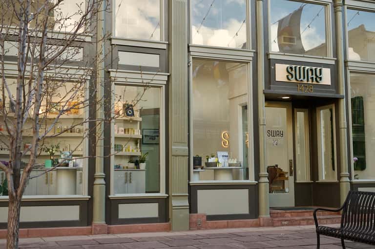 Modern storefront with glass windows and minimalist signage for Sway restaurant