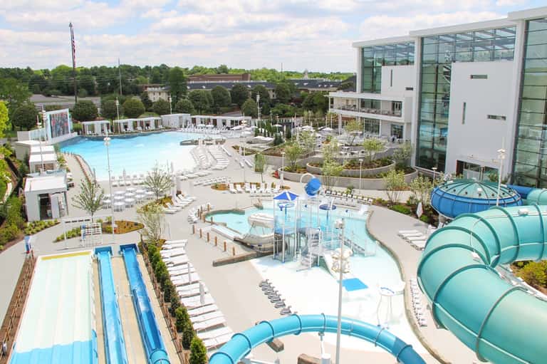 Aerial view of resort with multiple pools, water slides, spa facilities, and lounging areas