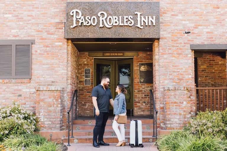 Historic brick building entrance of Paso Robles Inn with guests at entrance