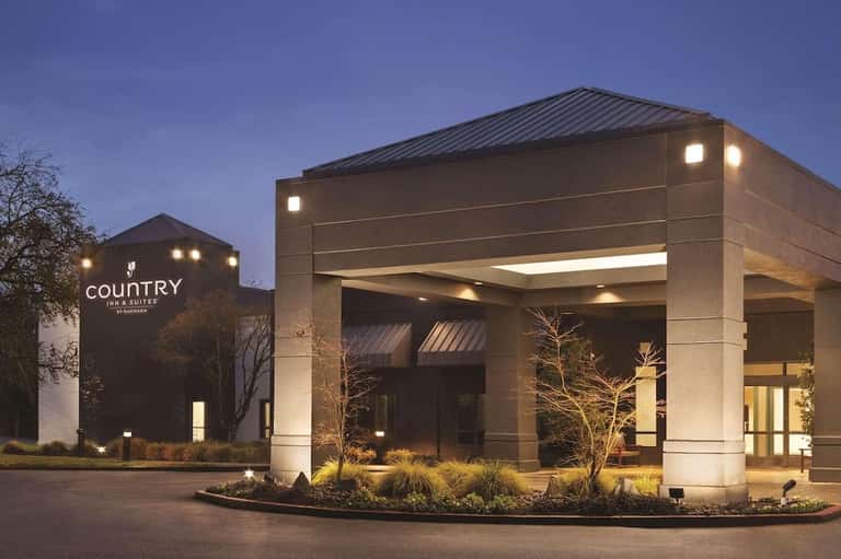 Country Inn & Suites modern entrance with stone facade and architectural canopy at night