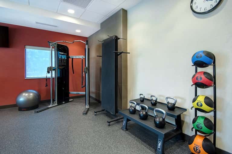 Fitness center with exercise equipment, kettlebells, medicine balls, and training machines