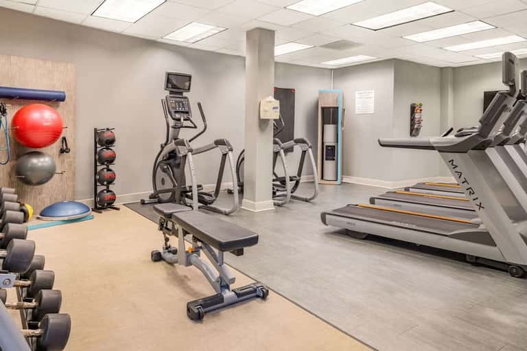 Well-equipped fitness center with treadmills, exercise bikes, free weights, and gym equipment