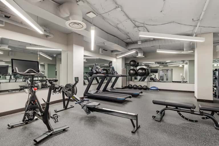 Modern fitness center with treadmills, stationary bikes, and equipment