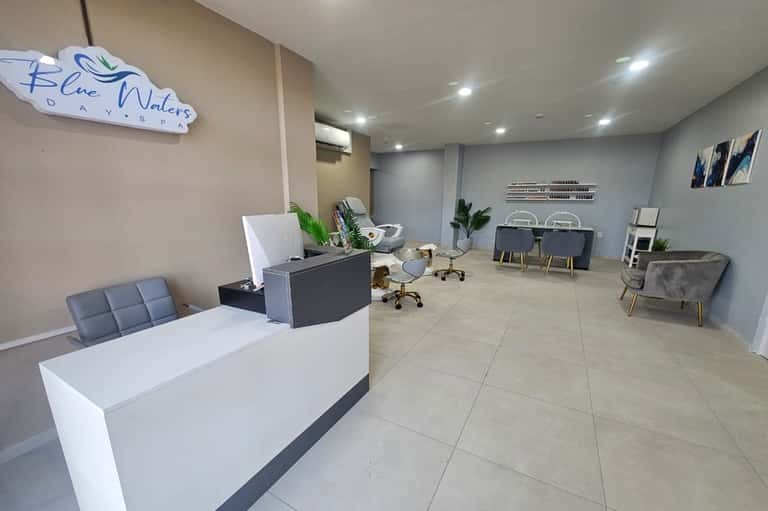 Modern hotel lobby reception desk with blue accent walls and contemporary seating area