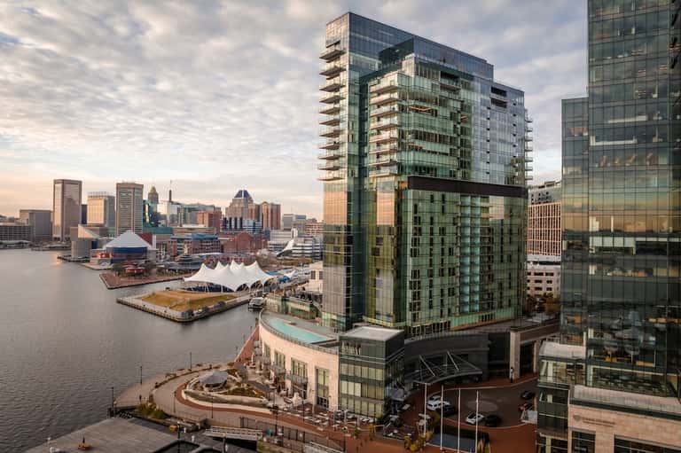 Waterfront high-rise hotel building with harbor view, city skyline, and modern architecture