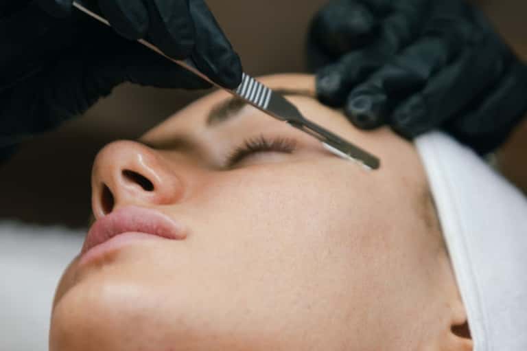 Close-up of facial treatment being applied with brush during spa procedure