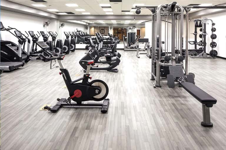 Modern fitness center with exercise bikes, weight machines, and strength training equipment
