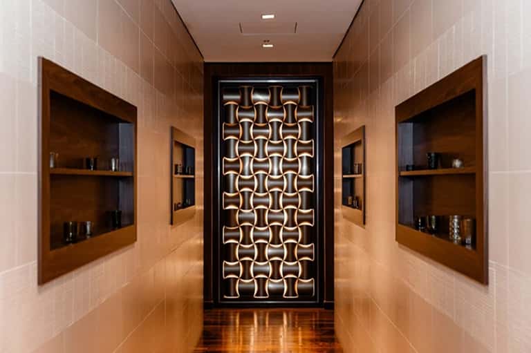Luxury spa corridor with neon geometric wall art and wooden shelving alcoves