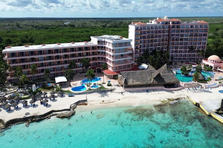 All-inclusive beachfront resort with multi-story buildings and turquoise pools