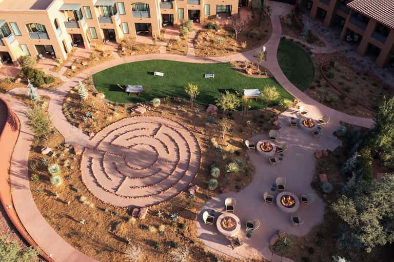 Aerial view of resort courtyard with spiral fire pit pattern and surrounding apartments