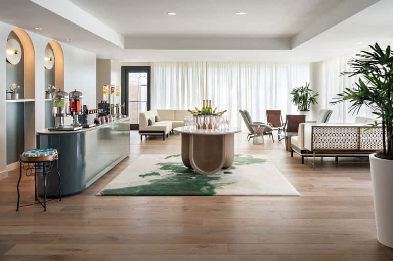 Luxury hotel lobby with reception desk, seating areas, and modern furnishings