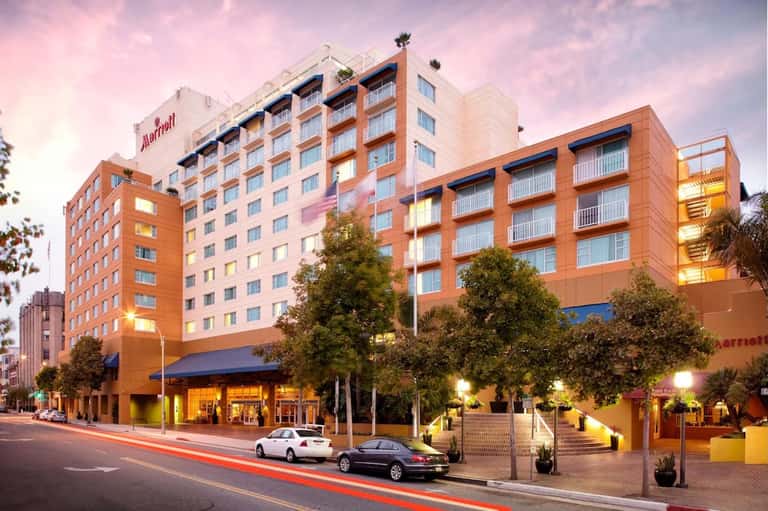 Marriott hotel exterior at dusk with illuminated orange brick facade and street view