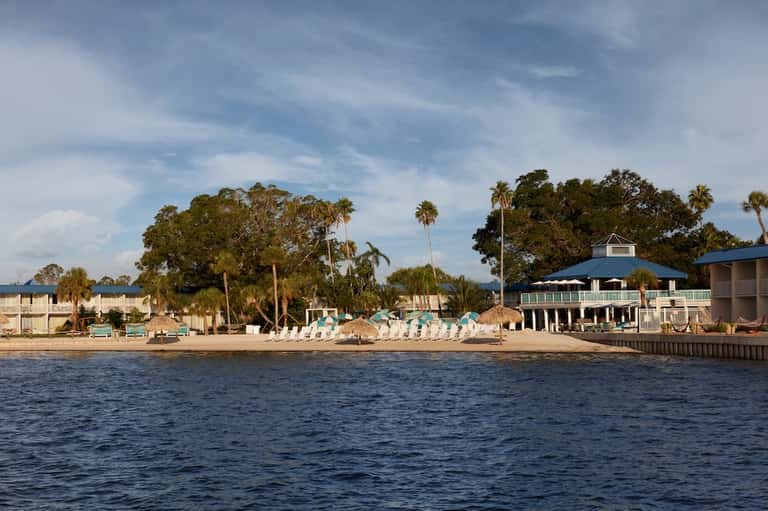 Beachfront resort buildings and dock viewed from the water