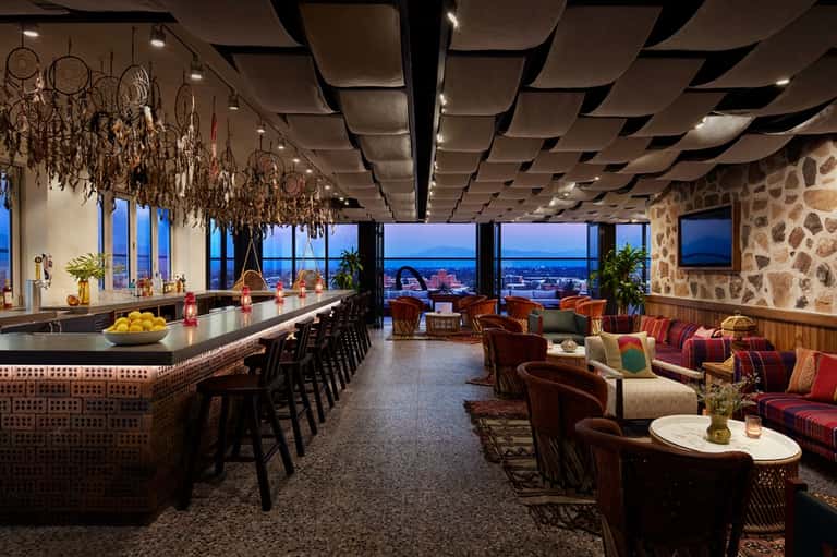 Modern rooftop bar and lounge with panoramic city views and sophisticated décor